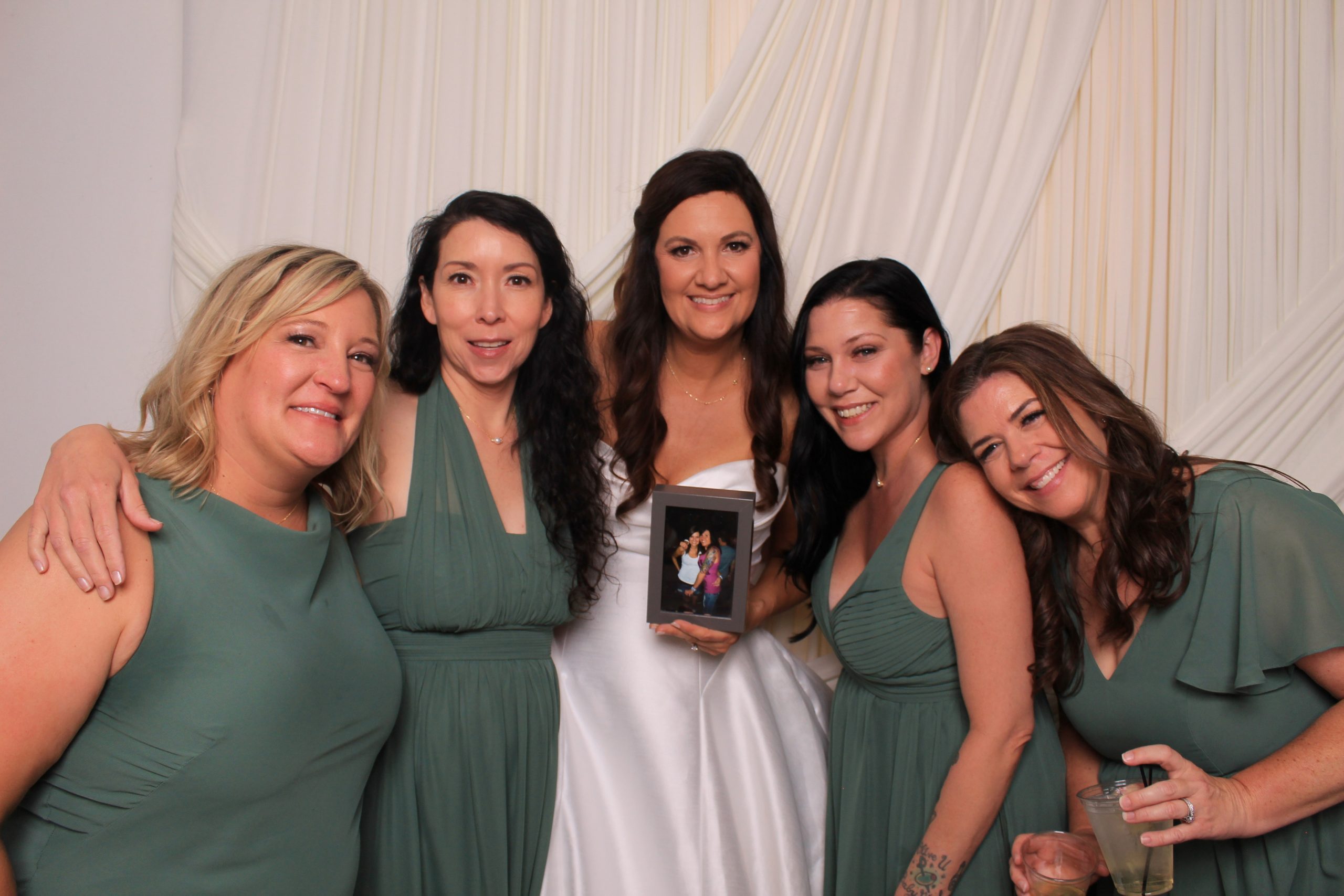 Bridesmaids in sage green at a Las Vegas wedding photo booth