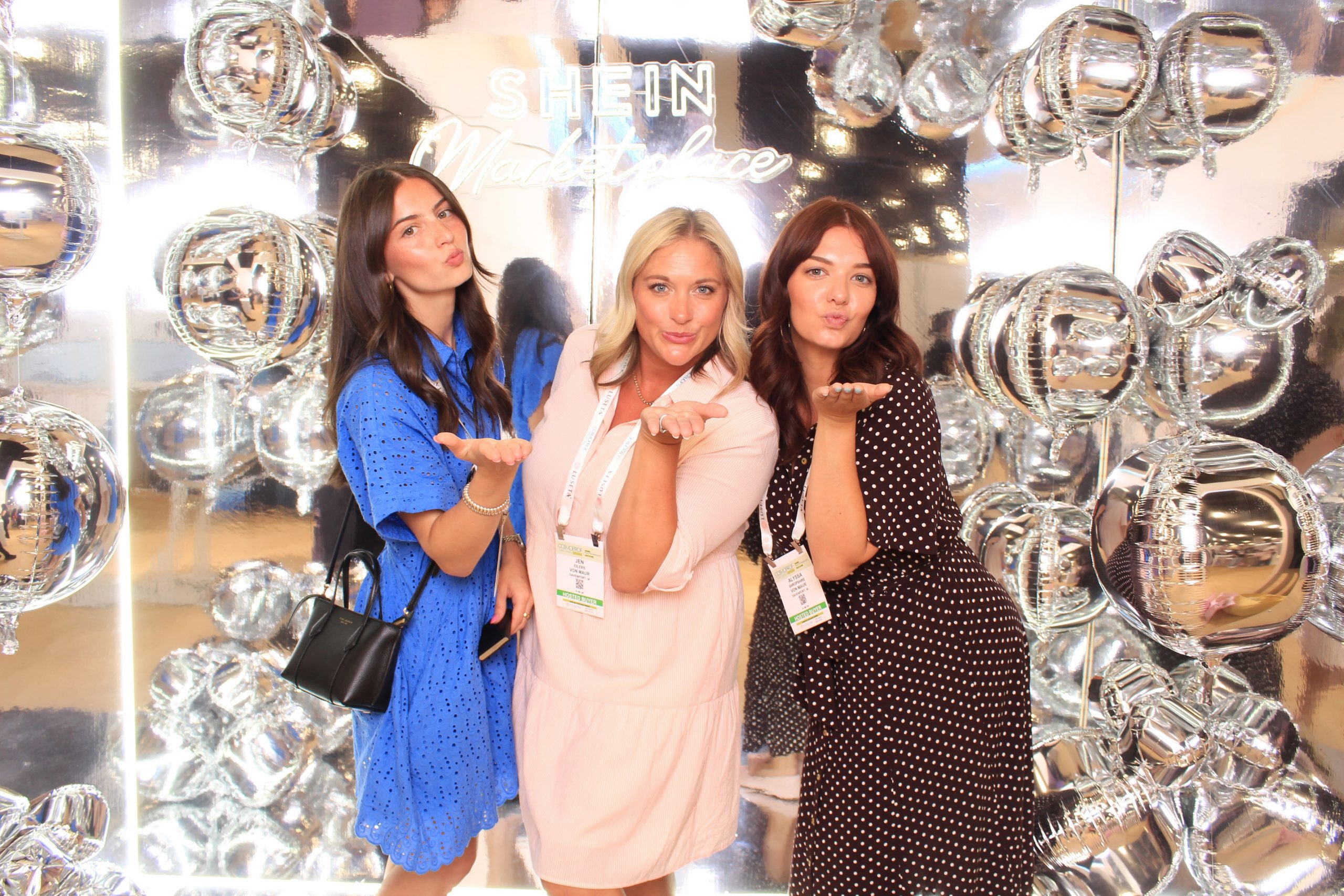 Group posing at an infinity mirror photo booth in Las Vegas