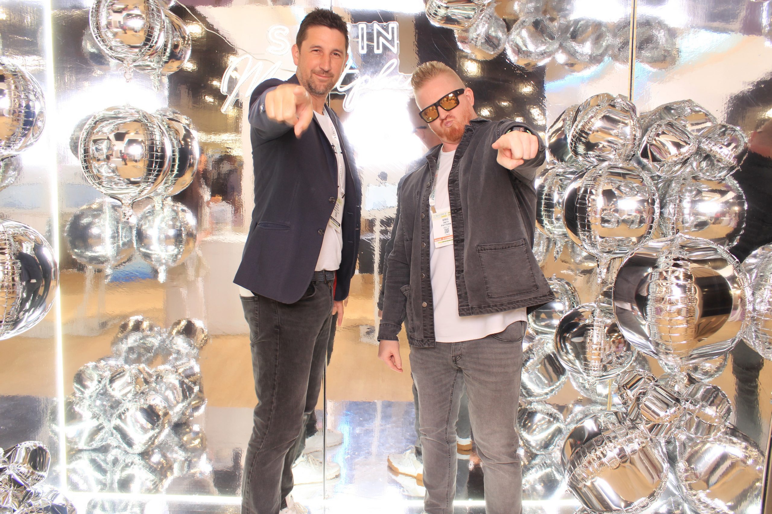 Guests posing at an infinity mirror photo booth in Las Vegas
